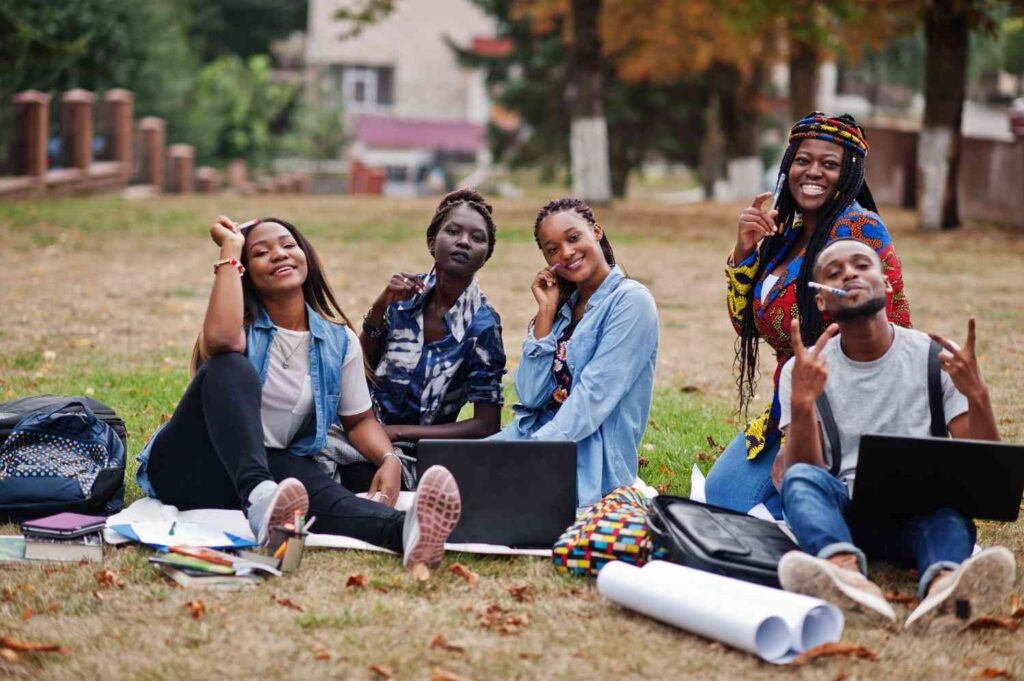 Young Nigerians in a sunny park discuss and support each other