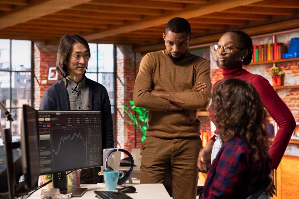 Nigerian investor analyzing stock market data on computer screens