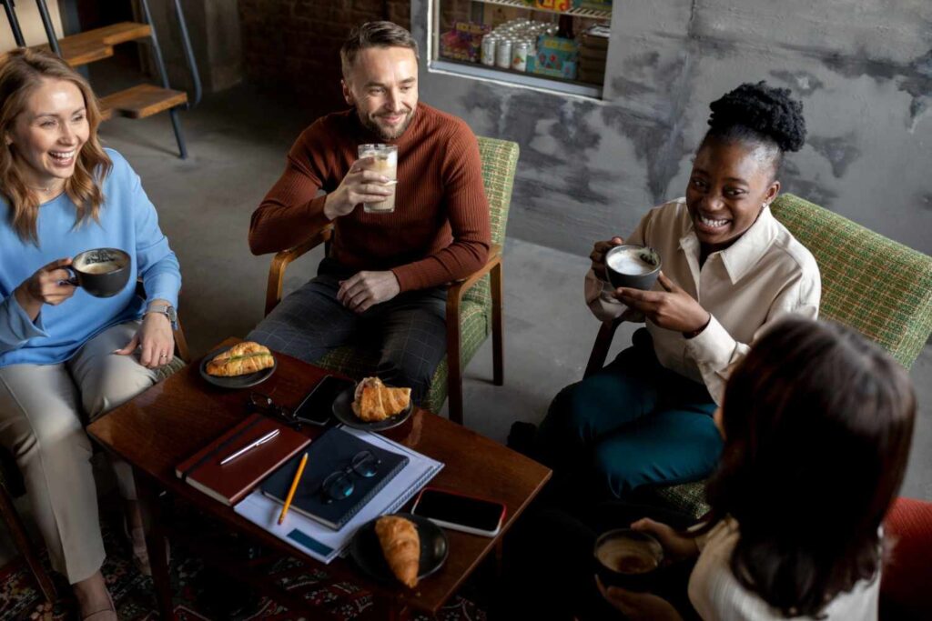 group of young adults gathered around a community center table, actively planning