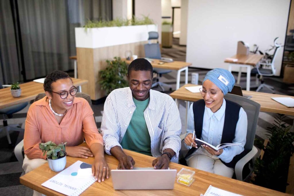Young Nigerians collaborating to discover their purpose in a vibrant co-working space.