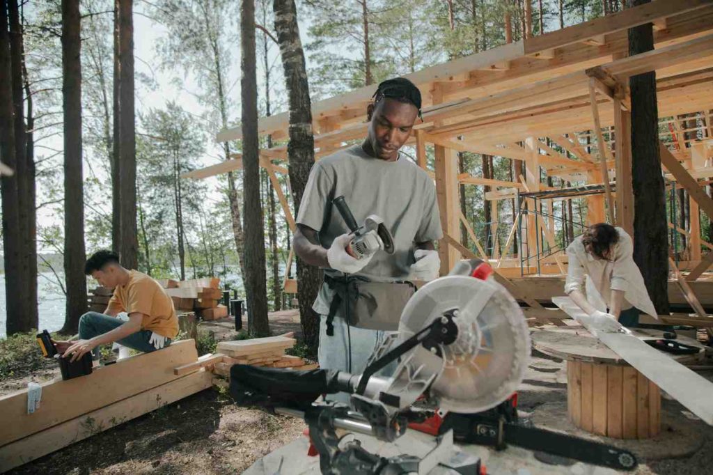 Youth in youth empowerment programs learning carpentry and tech skills with YEM.