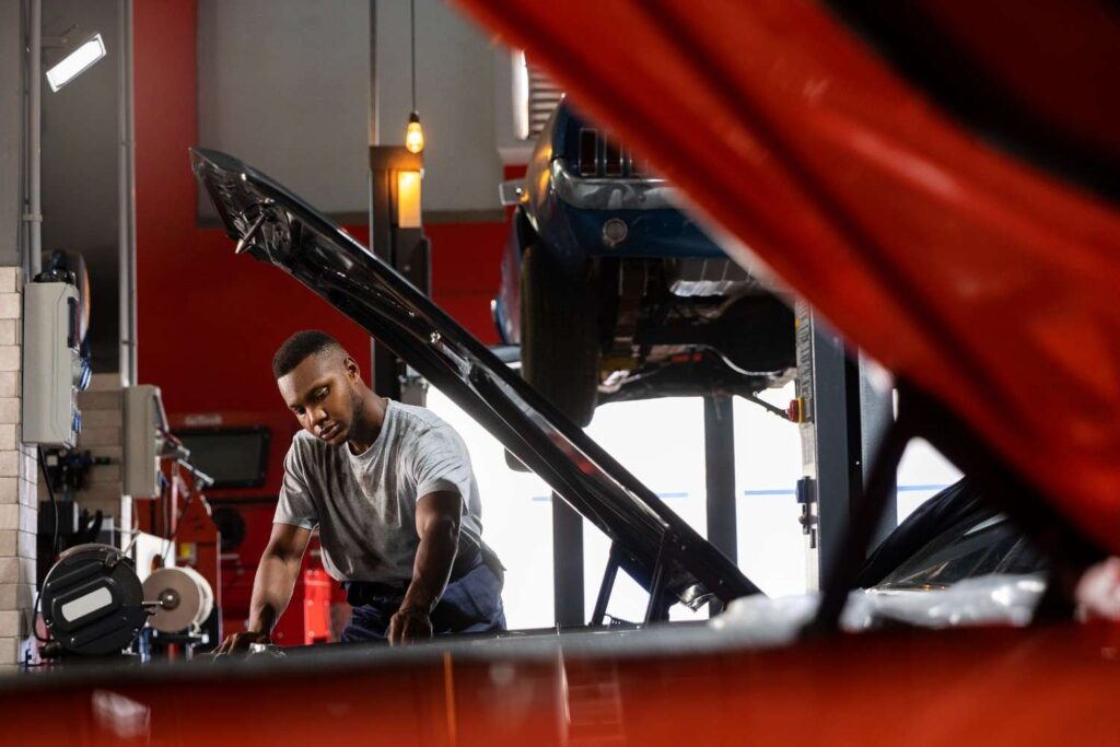 Nigerian mobile car mechanic servicing a vehicle at customer’s home